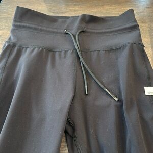 Vuori size small black leggings with cuff detail at bottom tie detail at top